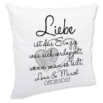 Flauschiges Kissen mit dem Spruch „Liebe ist das Einzige, was sich verdoppelt, wenn man es teilt“ und personalisierten Namen Lena & Marcel mit Datum 08.08.2022 auf weißem Hintergrund.